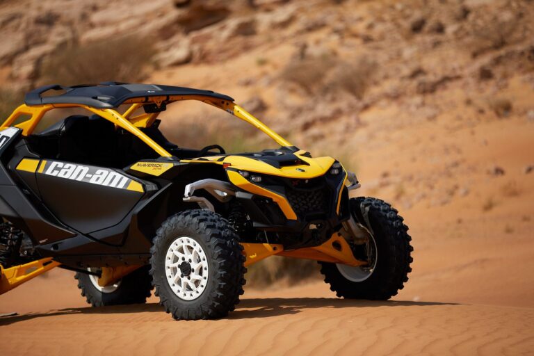 Close-up of a Can-Am Maverick R 2-seater buggy parked in the Dubai desert on an Early Bird tour