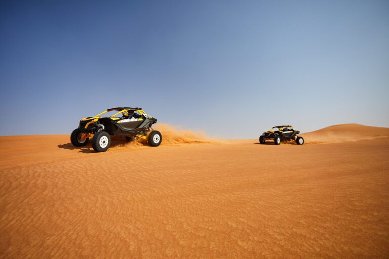 Two Can-Am Maverick R 2-seater buggies riding the open dunes on a 2-hour Early Bird tour in Dubai