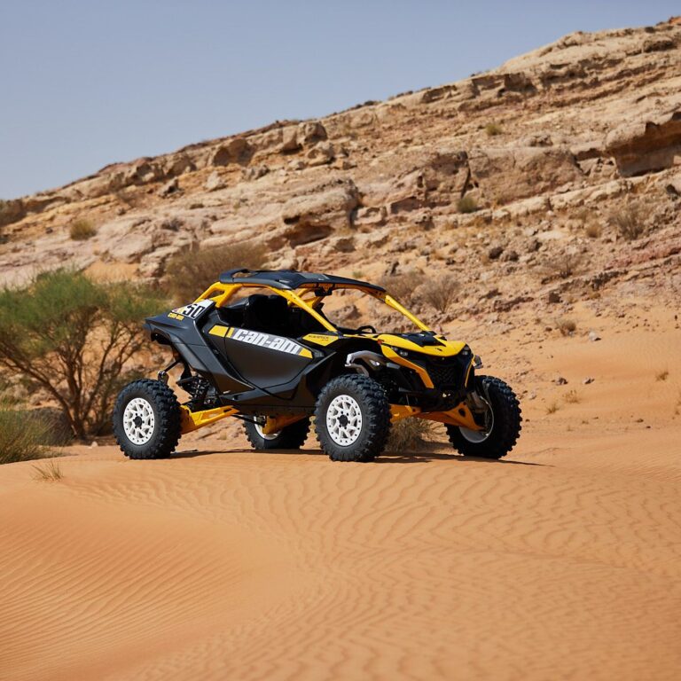 Can-Am Maverick R 2-seater buggy parked by rocky outcrops in the Dubai desert
